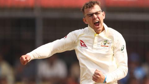 Matthew Kuhnemann of Australia celebrates taking a wicket against India