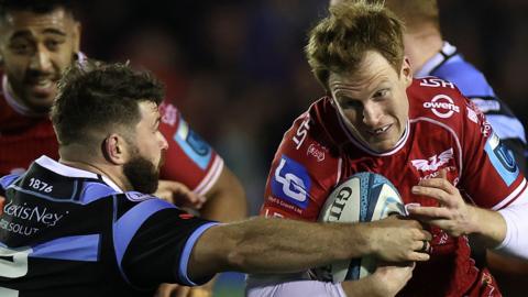 Cardiff's Kirby Myhill attempts to halt Rhys Patchell of Scarlets