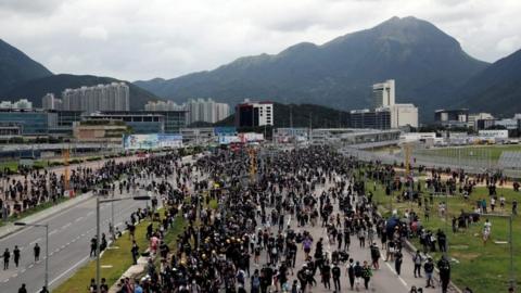 Pro-democracy protesters in Hong Kong have blocked roads to the territory's airport, disrupting the operation of the major Asian transport hub.