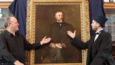 Ian Hammond Brown and Joe Whiteman with a portrait of Andrew Carnegie