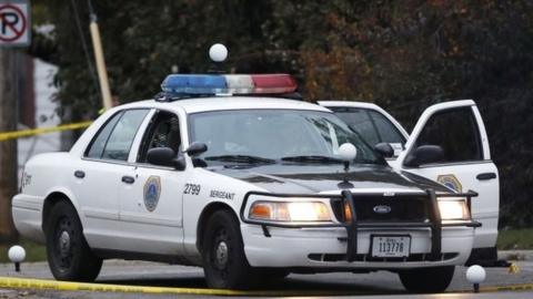 A Des Moines police department squad car with bullet holes seen on the passenger side door sits at the scene of a shooting, Wednesday, Nov. 2, 2016, in Des Moines, Iowa