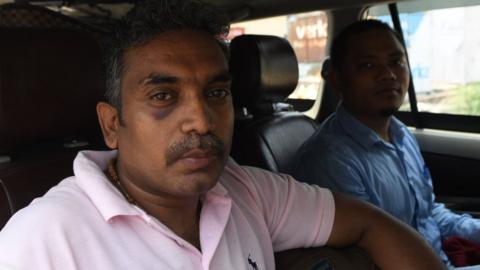 Selvadhas Paul (L) and Dwimu Brahms sit in a car at the India-Pakistan Wagah Border Post after their release from Pakistani authorities, 22 June