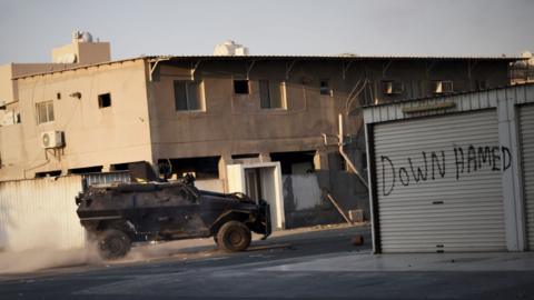 File photo showing Bahraini police vehicle patrols streets during clashes with protesters in Sitra, south of Manama, on 12 February 2016