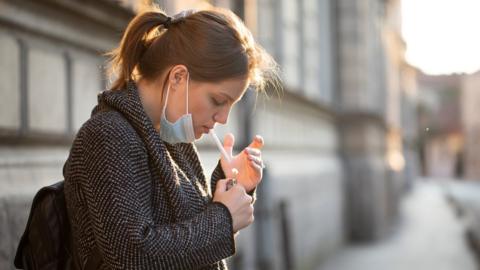 woman lighting a cigarette