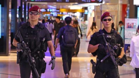 Heavily armed police patrol a Seoul shopping strip on 5 August, the weekend after a mass stabbing