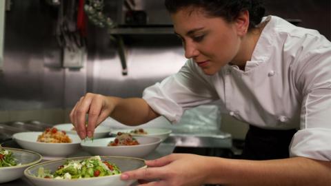 Stock image of a chef preparing food