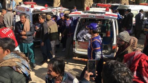 Rescue workers shift the bodies of the victims after 11 Shia minority people were killed by unknown gunmen in Mach on the outskirts of Quetta, Balochistan province, on 3 January 2021