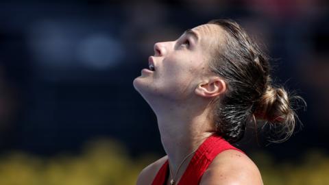 Aryna Sabalenka looks up to the sky