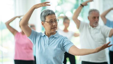 A class of people doing tai chi