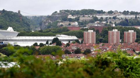 A wide view of Bristol with Ashton Gate stadium in the foreground and the Clifton Suspension Bridge in the background