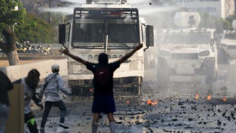 Anti-government protesters clash with security forces in Caracas on Wednesday