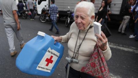 A woman receives a box of the first shipment of humanitarian aid from the Red Cross, in Caracas, Venezuela, 16 April 2019.