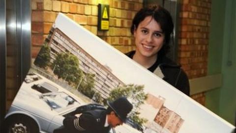 Georgia Macqueen Black holding a photo of a policeman