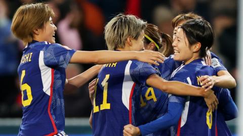 Japan celebrate scoring against Costa Rica