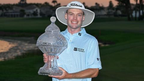 Joe Highsmith holding the Cognizant Classic trophy