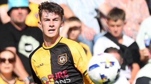 Newport County right-back Joe Thomas crosses the ball against Notts County
