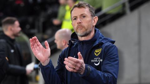 Oxford United boss Gary Rowett applauds the fans and looks on 