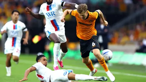 David Møller Wolfe of Wolverhampton Wanderers is tackled by Kristi Montgomery of Blackburn Rovers