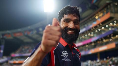 Nepal's Dipendra Singh Airee puts his thumb up to the camera