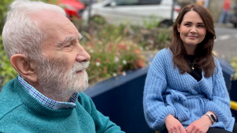 Brian Witherspoon and Stephanie Barton sitting on a bench