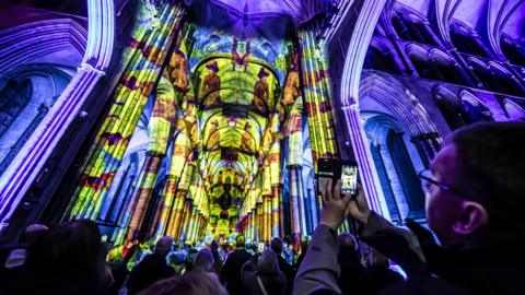 crowds watching art projections