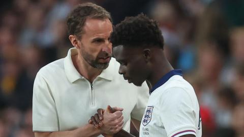 England manager Gareth Southgate (left) and Bukayo Saka