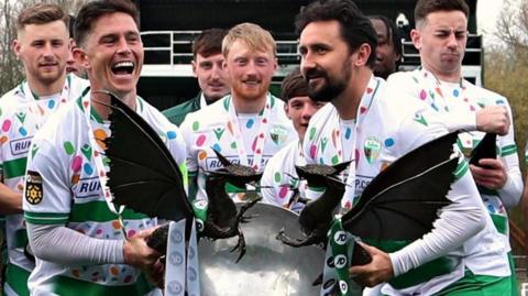New Saints players Danny Redmond and Ryan Brobbel hold the Cymru Premier trophy