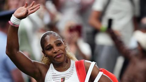 Serena Williams waves to the Wimbledon crowd