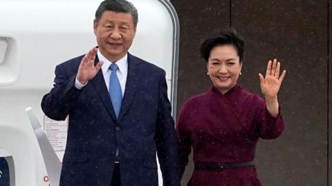 China's President Xi Jinping (L) and his wife Peng Liyuan wave upon their arrival for an official two-day state visit at Orly airport, south of Paris on May 5, 2024.