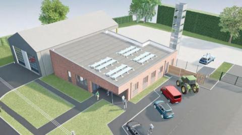 A computer-generated image showing an overhead view of the proposed fire station. It has double access doors for fire engines and a staff building to the side. There is a car park and a training tower in the background.