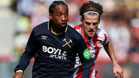 Kyle Walker-Peters is chased by Mathias Jensen during West Ham's Premier League match at Brentford.