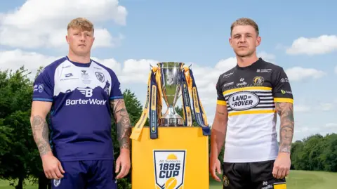 Featherstone's Danny Addy with York's Liam Harris and the AB Sundecks 1895 Cup.