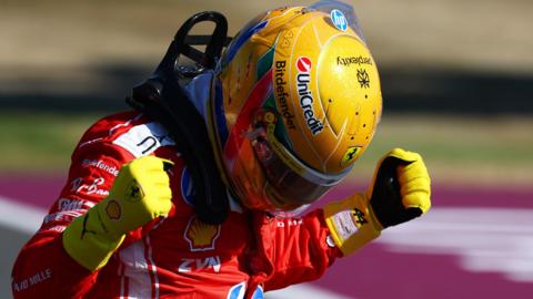 Ferrari's Lewis Hamilton clenches his fists in celebration after taking pole position for the British Grand Prix sprint race