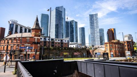 Manchester's skyline featuring a wide variety of buildings from traditional redbrick pubs to futuristic glass-fronted skyscrapers.