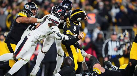 Aaron Rodgers of the Pittsburgh Steelers is sacked by Will Anderson of the Houston Texans