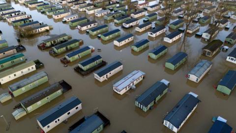 Park homes surrounded by flood water at Billing Aquadrome.