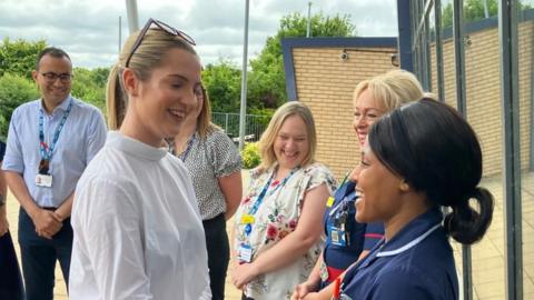 Rosie Wrighting talking to a nurse in uniform