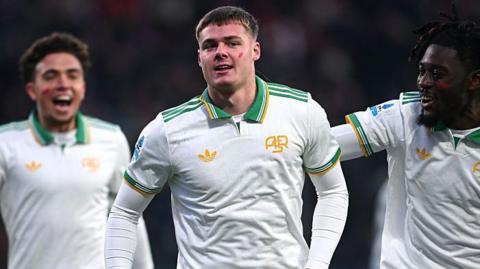 Evan Ferguson celebrates with his Roma team-mates after scoring his first Serie A goal