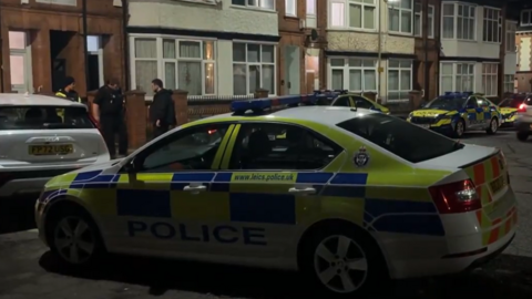 Four police cars parked outside of a house in Kimberley Road, Leicester