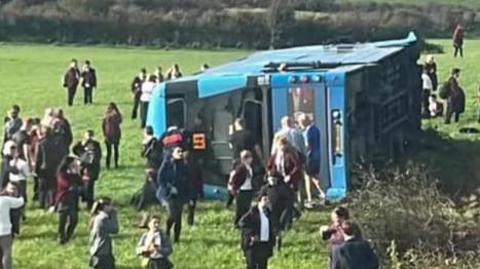 A bus on it's side