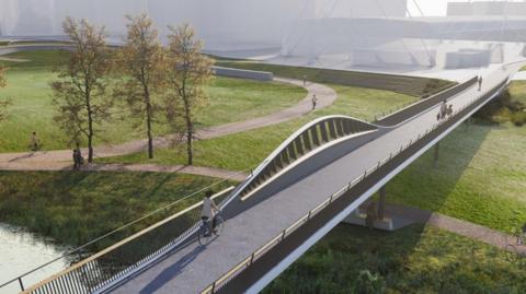 An architect's computed-generated image of a proposed walking and cycling bridge over Grandpont Nature Park in Oxford. The bridge stretches across a field with footpaths, and Oxford Ice Rink can be seen in the background. Trees are also visible near the river which the bridge goes over. 