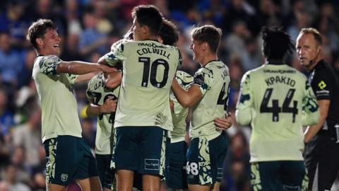 Cardiff players celebrate their late winner at Wimbledon
