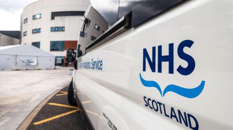 an NHS van outside a hospital