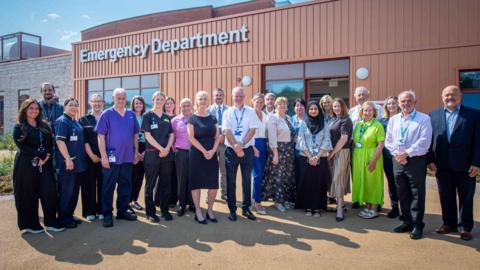 Colleagues from Wirral University Teaching Hospital, NHS England North West and NHS Cheshire and Merseyside pictured outside the new urgent and emergency care facility.
