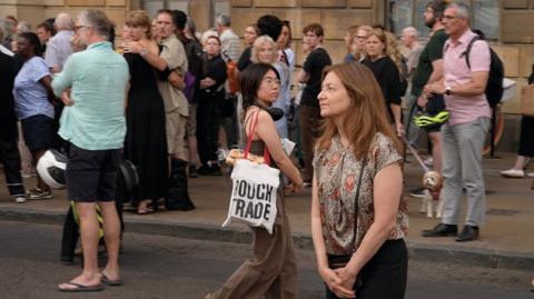 Deborah Prentice is part of a crowd at a vigil in Cambridge