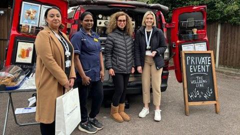 Care and NHS staff infront of the Hug in a Mug van