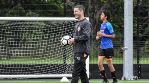 Gavin Step leads a kids training session on a football pitch