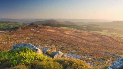 A landscape photo of hills and land over a large area. 