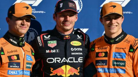 McLaren's Lando Norris, Red Bull's Max Verstappen and McLaren's Oscar Piastri stand together after qualifying in the top three for the 2025 Italian Grand Prix