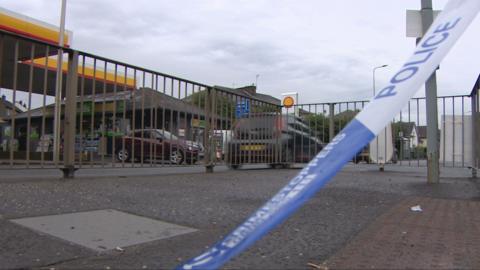 police tape on road outside